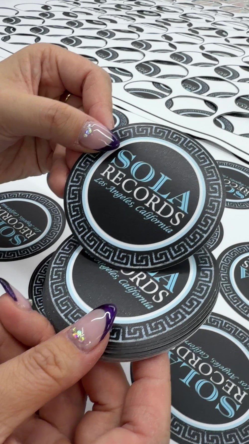 Finished custom vinyl stickers held by hand