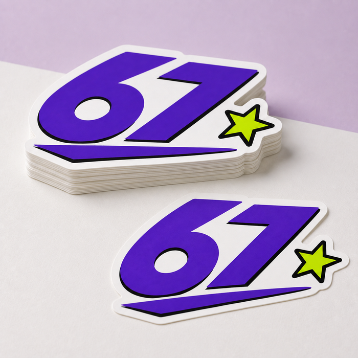Sample mockup of purple 67 die cut vinyl stickers in a small stack with one loose sticker.